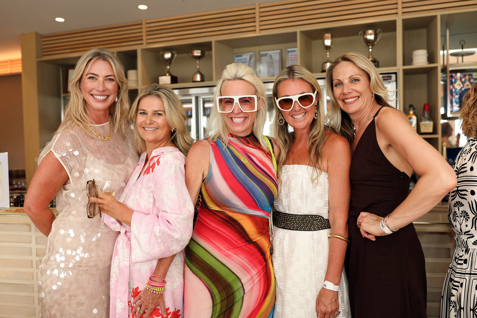 Five women photographed at a colourful Melbourne event