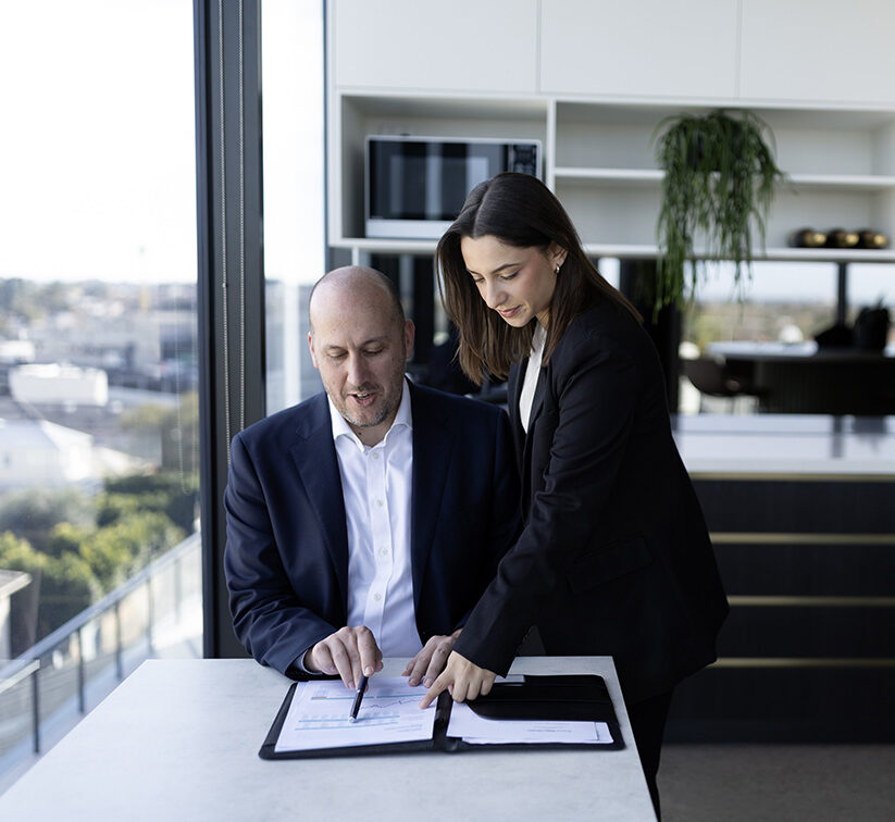Two colleagues collaborating in a modern workplace