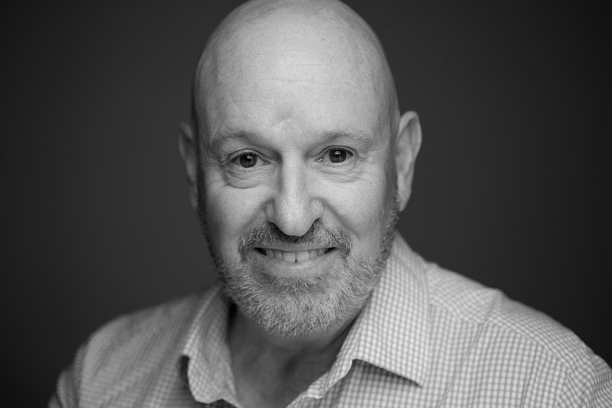 Black-and-white corporate headshot of a smiling professional in Melbourne