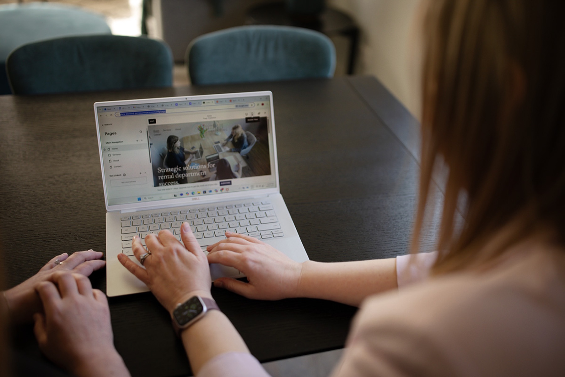 Marketing team member reviewing branded content on a laptop