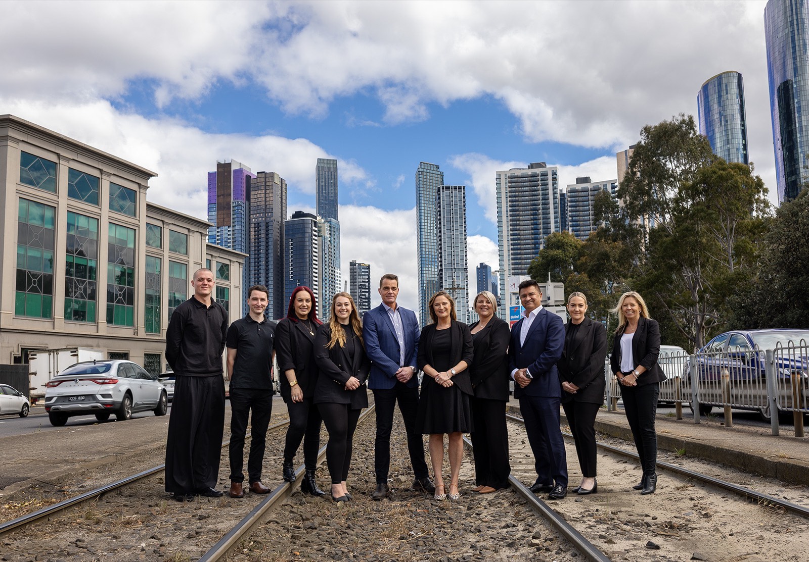 Melbourne corporate team photographed together with the city skyline behind them