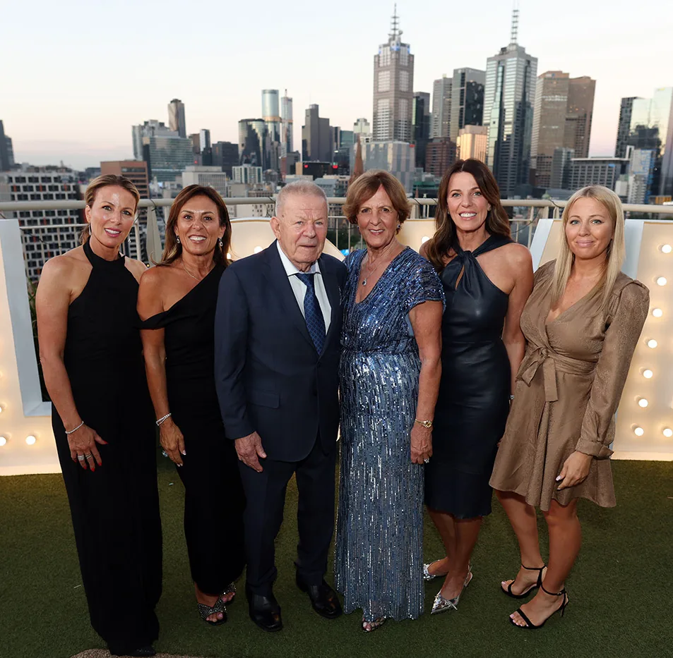 Gala dinner guests photographed with the Melbourne skyline