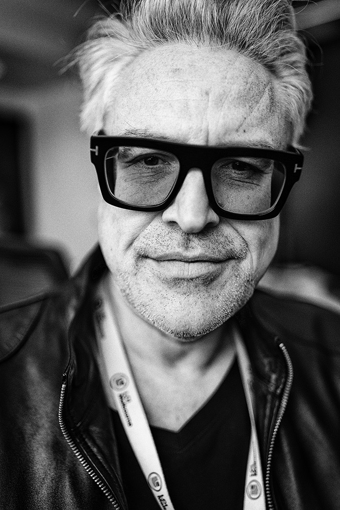 Natural black-and-white portrait of a man wearing bold glasses