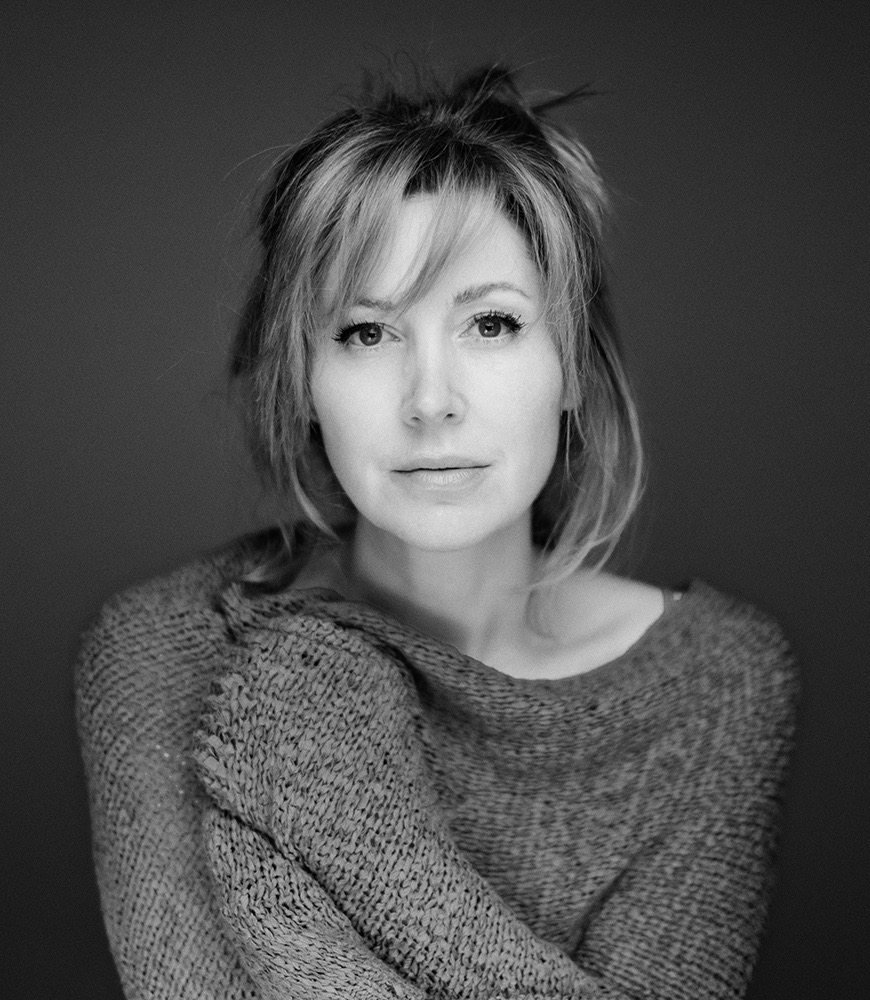 Black-and-white portrait of a woman in a textured top