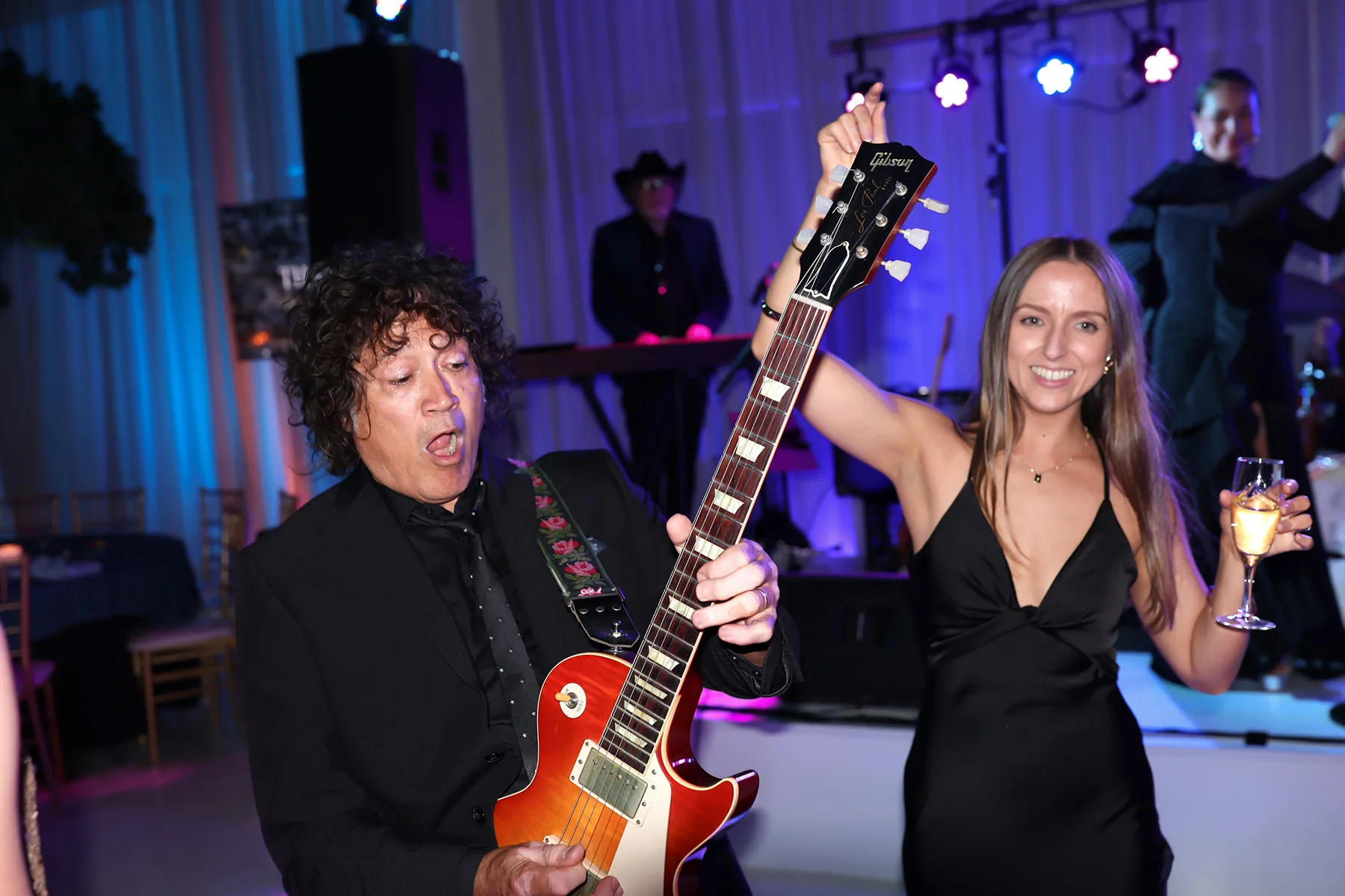Guitarist performing among guests at a Melbourne gala dinner